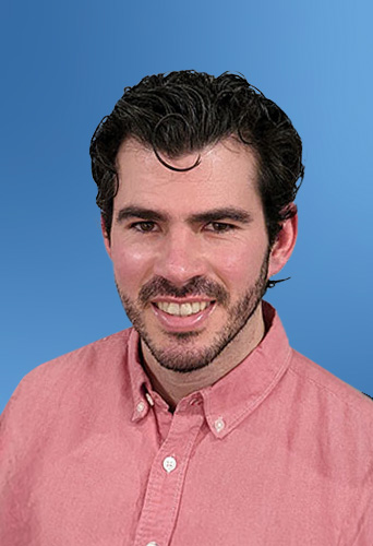 Man with dark curly hair and stubble, wearing a pink shirt designed with legal project management software icons against a blue background.